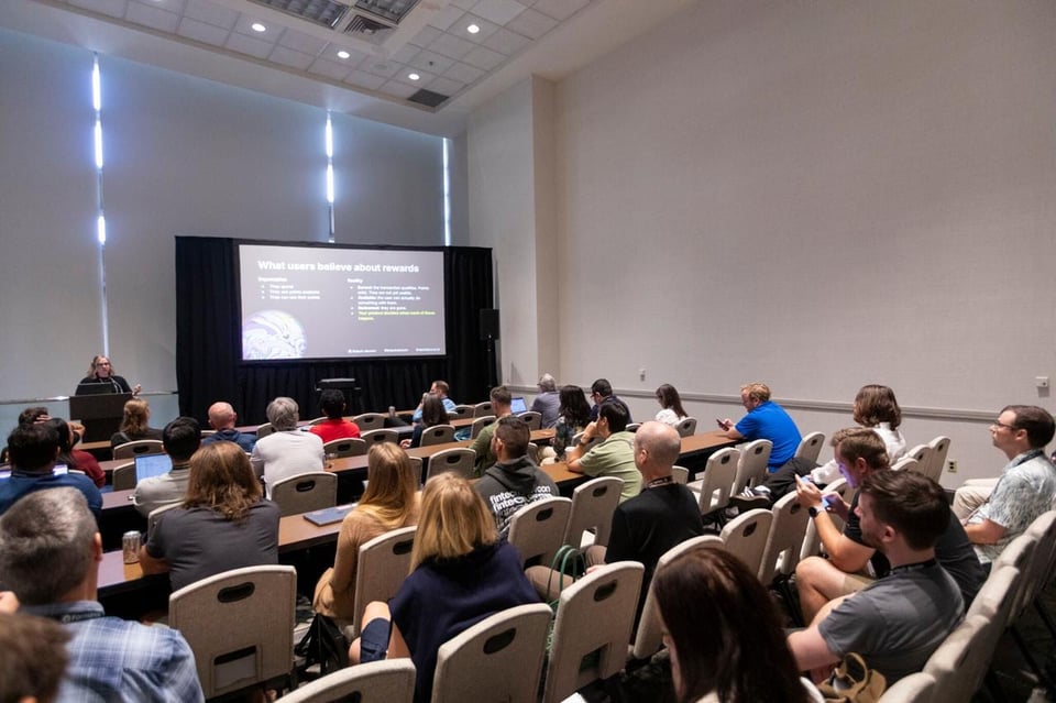 Ellen (author) presenting to an audience during a Fintech DevCon conference session.